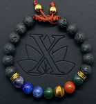 A seven gemstone chakra bracelet featuring lava beads and gold plated meander spacers. Utilizing a macramé technique for adjustability  